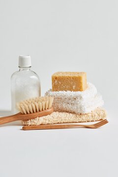 Minimal zero waste bathroom essentials with natural sponge, towels, wooden brush and reusable personal care accessories