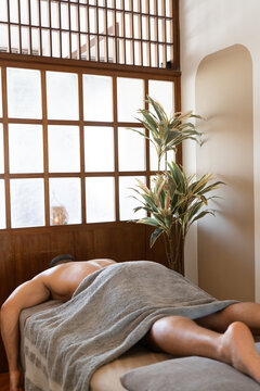 Client Relaxing on Massage Table at Wellness Spa