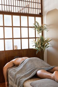 Client Relaxing on Massage Table at Wellness Spa