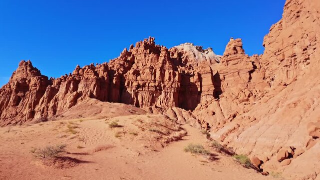 Morning sunlight illuminates unique sandstone goblins and weathered rock formations along the Basilisk Trail in Goblin Valley State Park Utah
