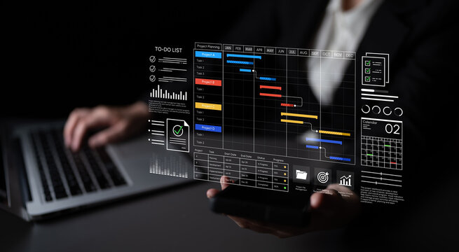 Futuristic Business Professional Interacting with Digital Project Management Interface While Using Laptop and Smartphone in Modern Office Setting. Entropy.