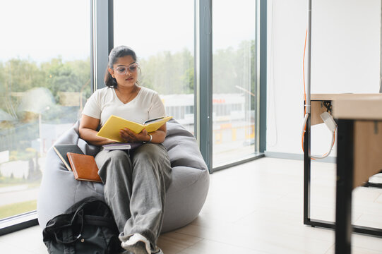 Indian female student studying alone in library