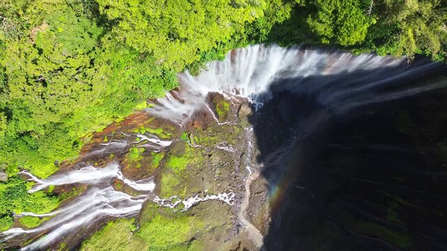 Aerial Top-Down View of Tumpak Sewu Waterfall with Rainbow