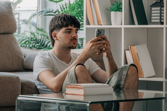 Student at home checking mobile phone