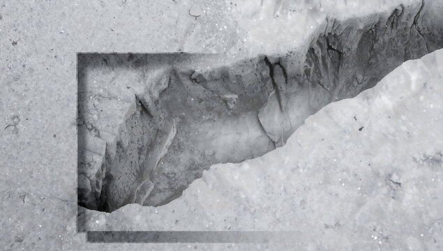 A close-up view of a jagged rock crevice partially framed by a rectangular border, showing rough gray stone textures and deep shadows in monochrome
