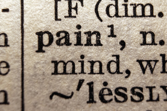 Word pain printed on dictionary page, macro close up
