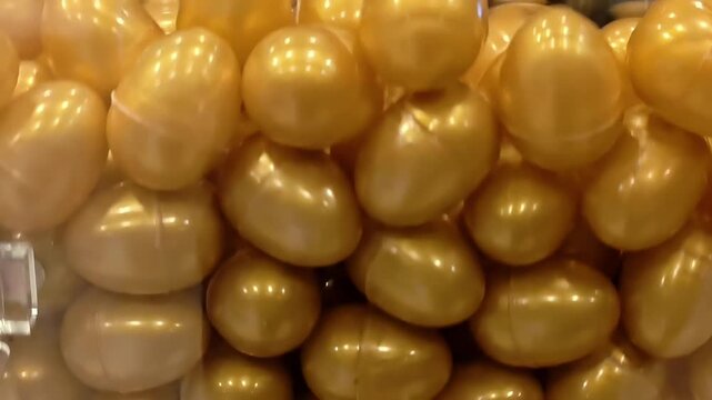 Plastic egg lottery tickets inside spinning raffle draw box, Lucky Random Prize Winner, Gambling Addiction, Betting Game, Surprise Fortune, Casino Metaphor, Closeup