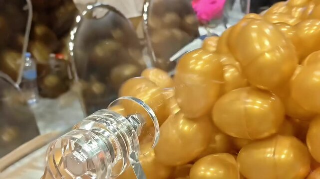 Hand spinning a raffle draw box with golden plastic egg lottery tickets, Lucky Prize Winner, Gambling Addiction, Betting Game, Surprise Reward, Casino Metaphor, Closeup Shot