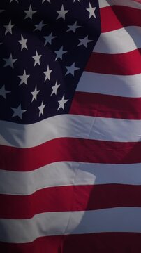 American flag waving against blue sky