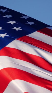 American flag waving against a blue sk