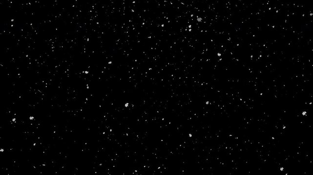 Seamless falling snow particles on black background. Perfect for winter overlay, holiday ads, and dynamic compositing video effects.
