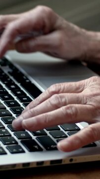 Senior hands typing on laptop keyboard - Old hand typing