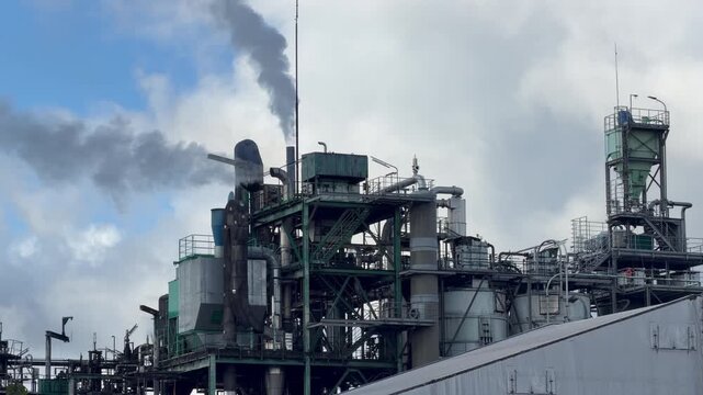 Zoom on a chimney of the Chemviron factory at Parentis en Born in the Landes. The shot closes on the stack against the sky. It illustrates the pine exploitation industry of southwest France.