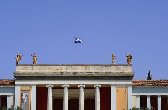 The roof of the archeological museum entrance, in Athens, Greece, decorated with statues of Apollo. Hera, Mars, Peace and Wealth