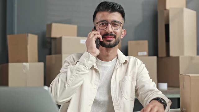 Man talks on phone, focused and serious
