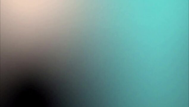 Abstract smooth gradient background with soft transition from beige to turquoise blue.