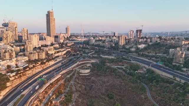 A time-lapse shot of traffic in Jerusalem, featuring high-rise buildings.