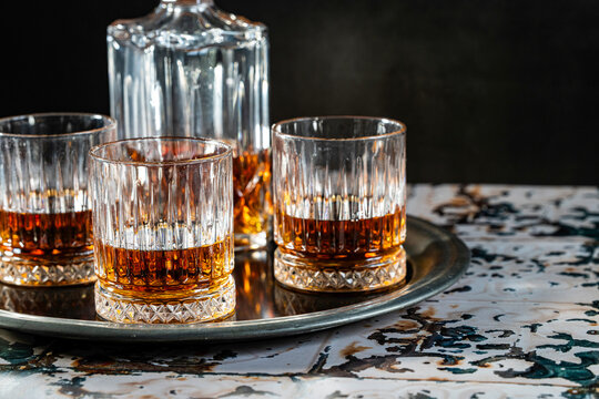 Bourbon in rocks glasses straight up with a decanter 
