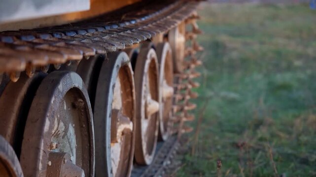 Extreme close up of rusty cogwheels on outdoor track showing weathered wood and metal gears in natural light for rustic machinery texture and industrial nature background
