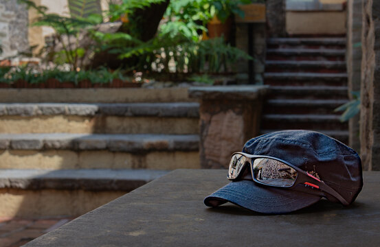 Hat with sunglass reflection in the garden area in Mexico 