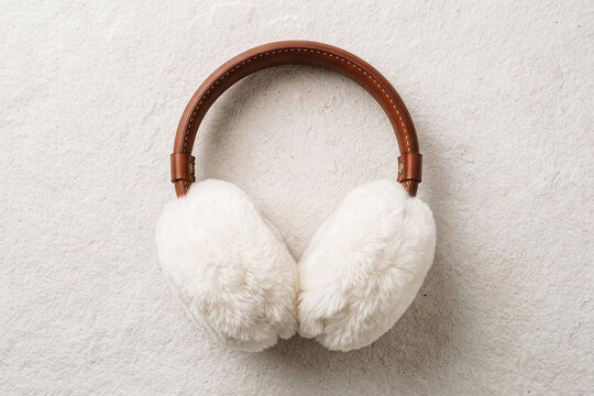 Leather earmuffs with fluffy faux fur ear pads on a white background