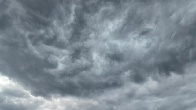 Black and gray clouds cover the sky. Clouds are approaching before a storm and rain with a thunderstorm