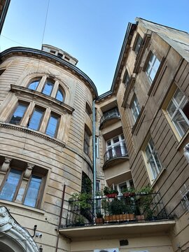  beautiful building with a balcony decorated with green plants