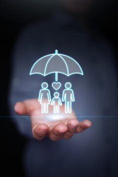 Open hand holding glowing family under umbrella hologram with heart icon. Life insurance, health coverage, family protection, security policy, and financial safety net. Vertical stock photo.