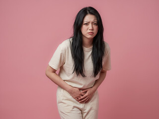 Fototapeta premium Woman bending forward with abdominal cramps