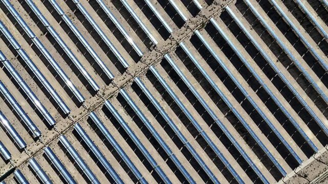 close up view of parabolic trough solar thermal power plant mirrors