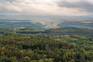Fototapeta premium Layers of green mountains and hills in the haze during sunset. Panoramic View of Green hills and Meadow.