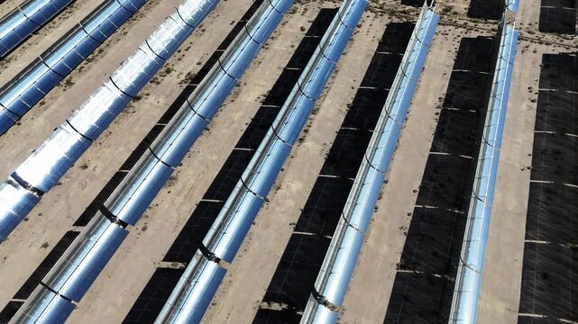 rows of parabolic trough solar thermal power plant in desert