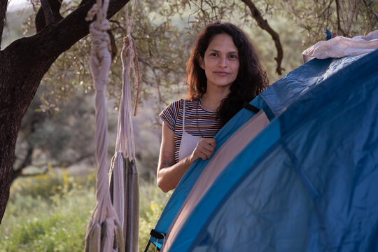 Woman enjoying camping by tent in nature