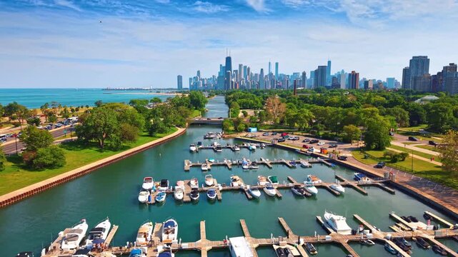 Flight over the boats at the berths in the beautiful harbor. Iconic skyline of Chicago, Illinois in the backdrop.
