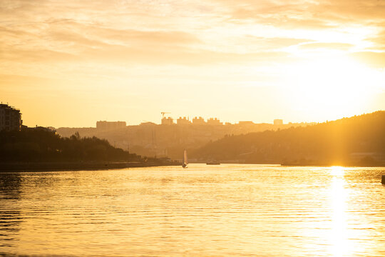 Golden sunset over the Golden Horn in Istanbul with a sailboat