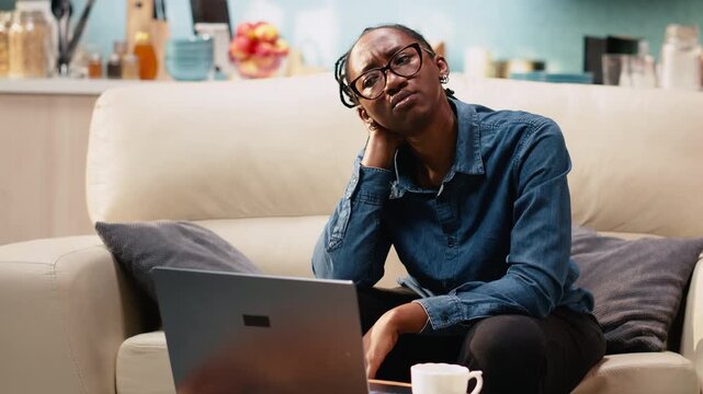 Overwhelmed woman receiving bad news during remote work, troubled and worried about difficult times and afraid of career failure, stressful situation.
