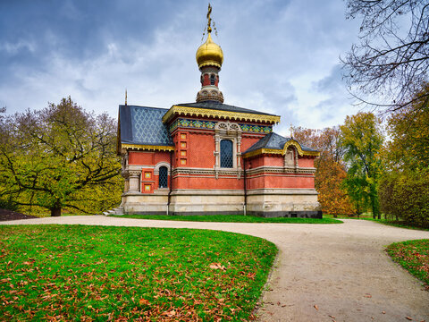 Red brick Russian church with a gold dome in Bad Homburg park