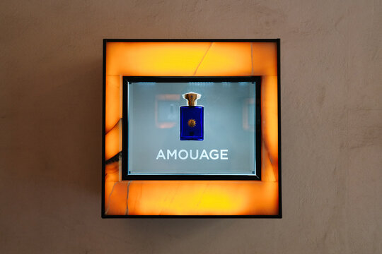 Florence, Italy - May, 16, 2025: Illuminated store display featuring Amouage Interlude Man Eau de Parfum. Vitrine of perfume shop