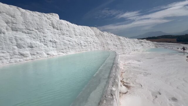 Stunning white travertine terraces filled with thermal spring water in Pamukkale, T&uuml;rkiye.	
