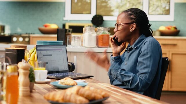 Black woman argues with call center agent about delivery delay or lost package and logistics issues. Real-time tracking verification supports customer service communication during a phone call.