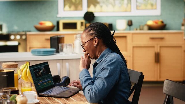 Video editor woman stretching muscles after assembling montage on laptop, video production and timeline editing, digital nomad videographer with cramps.