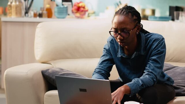 Distraught woman being troubled by work mistake and failure, struggling to avoid crisis or stressful situation. Worried anxious person working from home, puzzled and scared on the sofa.