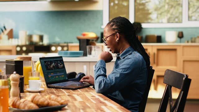 Woman videographer stretching back muscles after clips editing on laptop, video production and timeline editing with montage. Digital nomad with cramps and muscle stiffness at table.