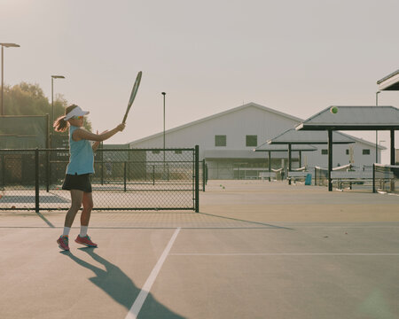 tennis player practising on court