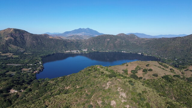 Santa Maria del Oro lake beyond rolling hills in an aerial landscape, Nayarit, Mexico