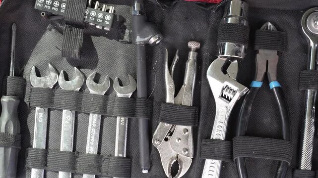 Tool organizer case filled with different wrenches and pliers, showcasing essential hand tools for repairs video