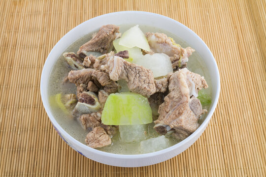 A bowl of light clear soup with pork ribs and winter melon, a simple and nutritious savory dish.