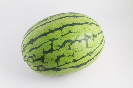 A whole oval watermelon with striped green rind, presented on a plain white background, a fresh fruit produce.