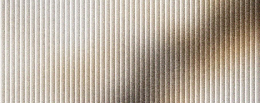 Corrugated metal texture with vertical lines and soft shadows. Industrial steel background with metallic ridges and neutral grey tones. Minimalist aluminum surface for architectural design.