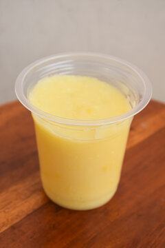 Fresh Mango Juice In Plastic Cup Vertical Angle